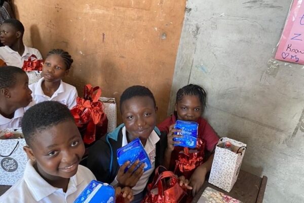 Some students of the Extra O School with the sanitary pads they were given